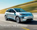 Un elegante automóvil eléctrico plateado se desplaza por una carretera escénica.