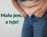 Osoba próbuje wcisnąć się w za małe jeansy, zmagając się z nadmiarem kilogramów. "Mało jem, a tyje!" - mówi.