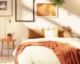 Acogedora habitación con decoración nórdica, cama con mantas y cojines cálidos, mesita de noche con planta y lámpara, y cuadros en la pared.