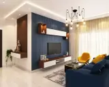 Nowoczesne wnętrze z niebieską ścianą, żółtym fotelem i granatową kanapą. Różne style wnętrz łączą się tu w harmonijną całość.
