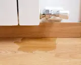 La caldera pierde presión y no hay fugas visibles, pero hay agua en el suelo de madera.