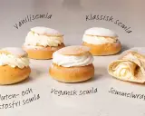 Fem olika semlor och en semmelwrap på ett marmorbord. Perfekt för semlor dagen!