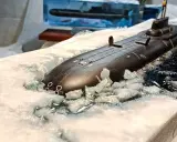 Ein Modell eines U-Bootes Akula bricht durch Eis und Wasser.