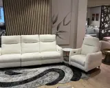 Sofá blanco de tres plazas y butaca a juego, perfectos para combinar sofá y butaca en tu salón. Alfombra moderna y cuadro decorativo.
