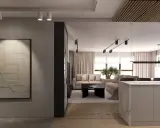 Nowoczesny salon z sofami w kolorze mokka, kamienną wyspą i abstrakcyjnym obrazem na ścianie.