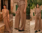 A woman models a chic beige linen pants outfit, showcasing a flowy wrap top and wide-leg trousers with stylish side slits.