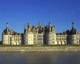 Majestatyczny zamek Chambord, perła Doliny Loary, wznosi się nad spokojną rzeką.