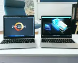 Deux ordinateurs portables côte à côte, l'un affichant le logo Ryzen, l'autre le logo Intel Core Ultra. Un **framework computer** pour chaque processeur.