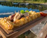 En härlig plankstek med krämig potatis och en god sås, perfekt att njuta av med ett glas vin vid vattnet.