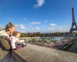Madre y bebé disfrutan de la Torre Eiffel y las fuentes en Francia con niños.