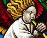 Un ange soufflant dans une trompette, une œuvre d'art vitraux aux couleurs vives.