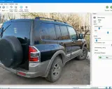 Software per correggere foto mosse. L'immagine mostra un SUV nero con una ruota di scorta sul retro, pronto per essere elaborato.