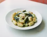 Pyszne gnocchi z sosem, posypane parmezanem i ozdobione listkami szałwii. Idealne danie dla miłośników włoskiej kuchni.