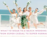 Bridesmaids in white dresses celebrate by the ocean. Thinking about what to wear to a beach wedding male? This image offers inspiration for stylish beach attire.