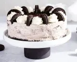 Pyszny sernik oreo na zimno, udekorowany bitą śmietaną i ciasteczkami. Idealny deser na upalne dni.