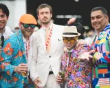 Men at the Kentucky Derby sport vibrant, patterned suits, showcasing bold fashion choices.