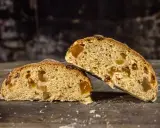 Deux tranches de pain au levain de gingembre, garnies de fruits confits, sur une table en bois rustique.