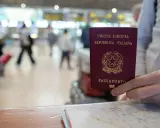 Włoski paszport w dłoni, gotowy do podróży po Europie. To idealny sposób na wakacje bez paszportu, gdy podróżujesz w strefie Schengen.