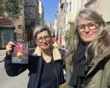 Deux femmes, l'une tenant un livre, dans une rue de Marseille. Le visage de madone de l'une d'elles est encadré par des lunettes.