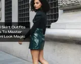 A woman models a shiny green mini skirt and black top, showcasing a chic mini skirt and boots outfit idea.