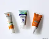 Trois tubes de crème solaire (La Roche-Posay, Dermale, Avène) pour montrer à quoi sert la crème solaire : protéger la peau des rayons UV.