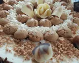 Torta decorata con biscotti, panna montata, cioccolato bianco a forma di rosa e granella. Il re del gelato trama, un capolavoro da gustare.
