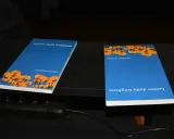 Due libri "Lettere dalla Kirghisia" di Silvano Agosti, con copertina blu e fiori arancioni.