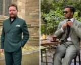 Two men in stylish suits. One wears a dark green suit with a black shirt, the other a lighter green suit with a white shirt and brown tie.