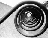 A spiral staircase, reminiscent of Edward Weston's famous photos, draws the eye inward.