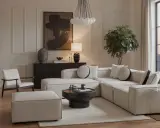 Un soggiorno con un divano componibile bianco, tavolino nero, poltrona e pouf. L'arredamento riflette uno stile contemporaneo casa, con un quadro astratto e una lampada di design.