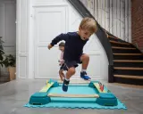 Bambini di 4 anni si divertono con la psicomotricità, saltando su un percorso a ostacoli colorato.