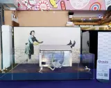Banksy's "Girl with Balloon" installation, a prime example of art investment, displayed with a fridge and chair.