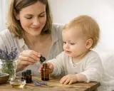 Une mère et son enfant découvrent les bienfaits de l'huile essentielle de lavande. Des brins de lavande fraîche et des petits flacons sont disposés sur une table en bois.