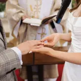 Panna Młoda zakłada obrączkę na palec Pana Młodego. Ceremonia ślub jednostronny w kościele.