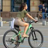 Dziewczyna na rowerze, która uczy się, jak zmieniać przerzutki w rowerze, by jazda była płynniejsza.