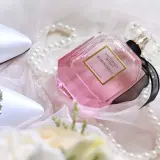 Eleganckie białe buty z kryształkami, różowe oznaczenia perfum Victoria's Secret Bombshell i perły na delikatnym tiulu.