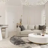 Nowoczesny salon z sofą, stolikiem kawowym i okrągłym dywanem.