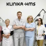 Zespół medyczny Kliniki HMS w Zielonej Górze: sześć osób w strojach medycznych i garniturze.