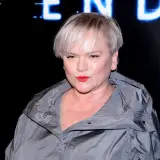 Katarzyna Figura, wiek nie gra roli, gdy ma się taki styl. Aktorka w szarej kurtce i z mocnym makijażem.