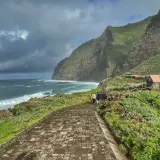 A scenic walk along the coast of Madeira, with dramatic cliffs and crashing waves. This view captures the essence of a week in Madeira.