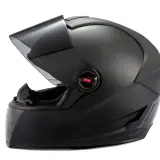 Casco de moto negro mate con visor ahumado levantado. Ideal para reparar casco moto y mantener tu equipo en óptimas condiciones.
