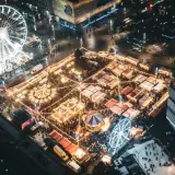 Nocny jarmark bożonarodzeniowy Katowice: rozświetlone stoiska, karuzela, diabelski młyn i lodowisko tworzą magiczną atmosferę.