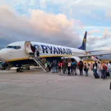 Pasażerowie wsiadają do samolotu Ryanair. Dowiedz się, jak wydrukować bilet lotniczy Ryanair, aby podróż przebiegła sprawnie.