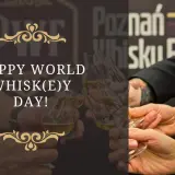 Wznosimy toasty za międzynarodowy dzień whisky! Kilka par rąk trzyma kieliszki z bursztynowym trunkiem.