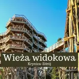Drewniana wieża widokowa w Krynicy-Zdroju wznosi się ku błękitnemu niebu, oferując wspaniałe widoki na okolicę.