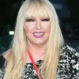 Maryla Rodowicz w czarno-białej sukience z ozdobnym wzorem, z długimi blond włosami i makijażem.