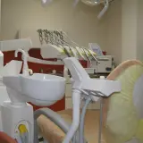 Nowoczesny gabinet stomatologiczny z fotelem dentystycznym i narzędziami.