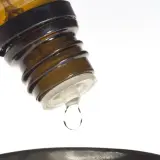 Kropla leku z buteleczki, jak zyrtec krople, spada do naczynia.