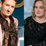 Filip Cembala, partner, w różowej marynarce i z falbaniastą koszulą, obok kobiety w czarnej bluzce.