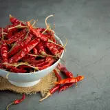 Suszone papryczki chili w misce. To one zawierają kapsaicynę, która nadaje im ostrość.